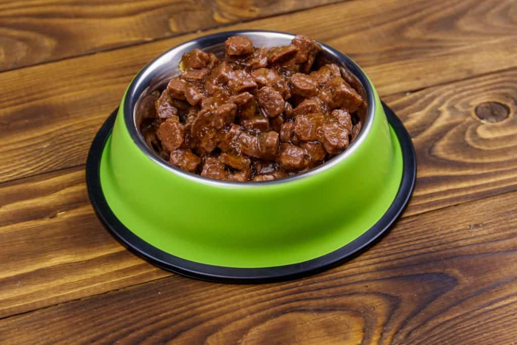 An up close photo of cat food on a wooden table